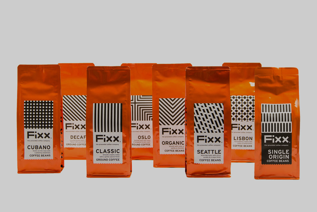 A selection of vibrent orange bags of FiXX Coffee