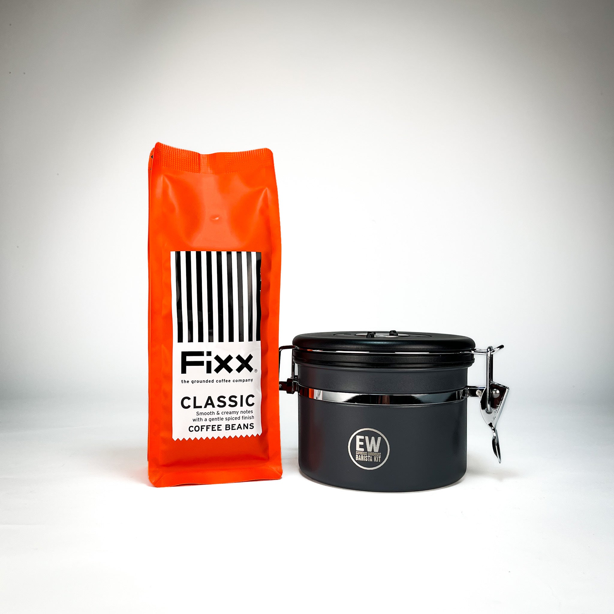 Orange Fixx coffee beans bag and black container on a white background
