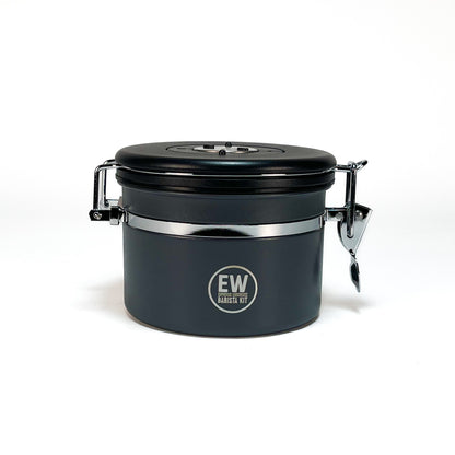 Black container with a lid on a white background, featuring the brand &