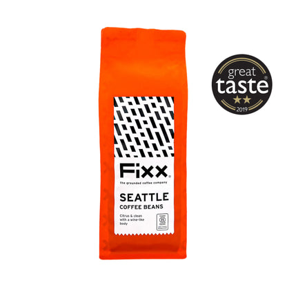 Orange package of Fixx Seattle Coffee Beans with a Great Taste award badge on a white background