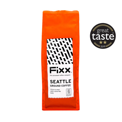 Orange package of Fixx Seattle ground coffee with a Great Taste award badge on a white background