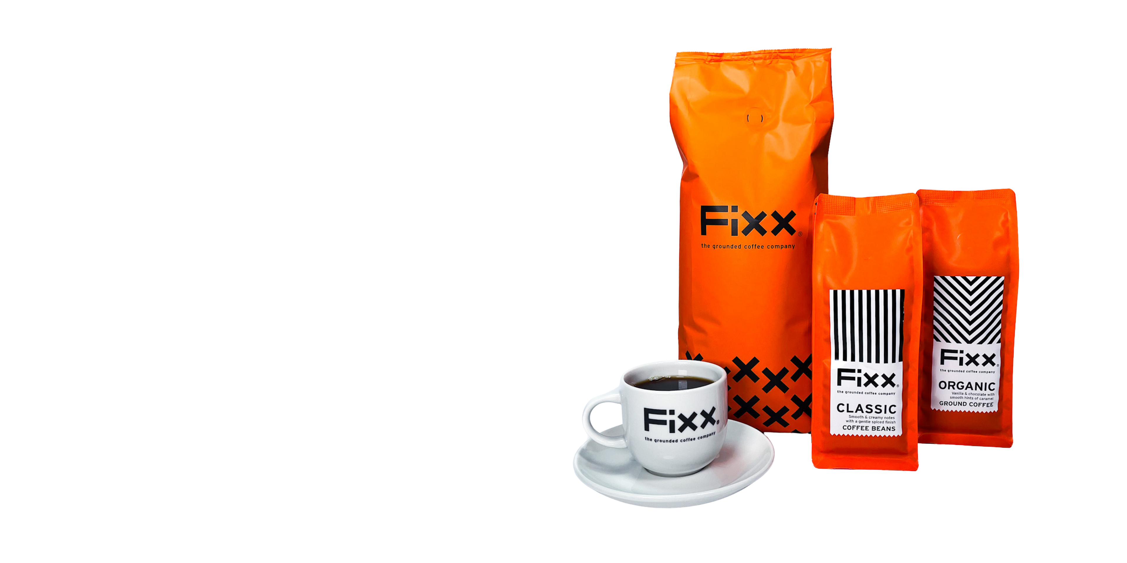 Three orange Fixx coffee bags with a white cup and saucer on a white background
