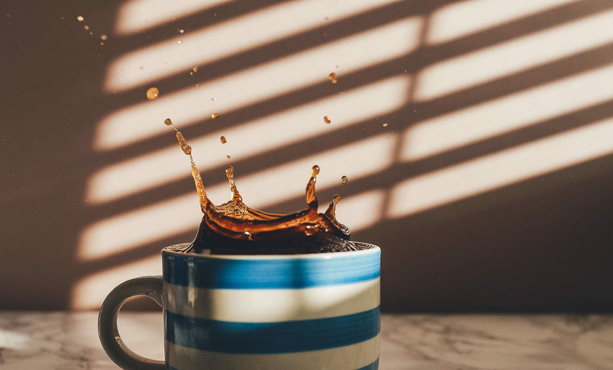 coffee splash in blue white mug