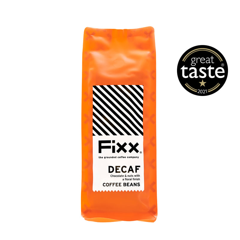 An orange pack of FiXX Decaf Coffee Beans, with a &