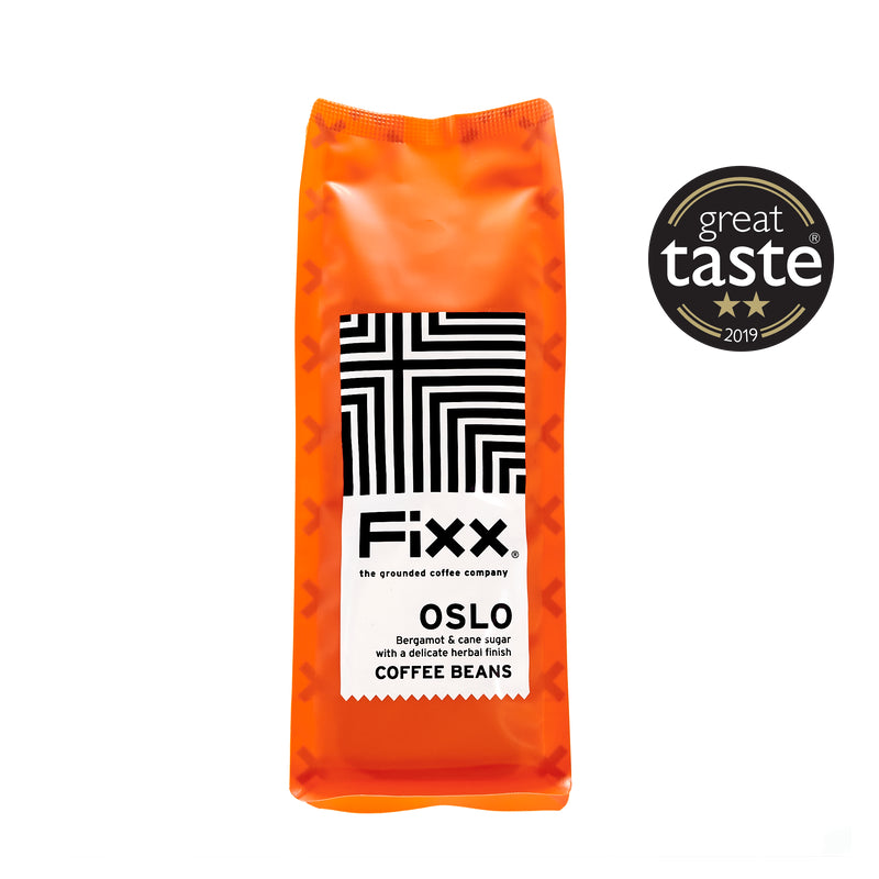 A pack of FiXX Oslo coffee beans with bright orange packaging and a black and white geometric design. It has a label indicating it&